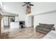 Sun-filled living room boasts wood floors, open layout, and seamless flow to kitchen at 14170 W Warren Dr, Lakewood, CO 80228