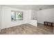Bright living room featuring wood-look floors, and lots of natural light through large windows, ready for personalization at 14170 W Warren Dr, Lakewood, CO 80228