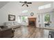 Bright living room features vaulted ceiling, wood floors, fireplace, and access to outdoor deck at 14170 W Warren Dr, Lakewood, CO 80228