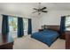 Spacious main bedroom offers large windows, a ceiling fan, and ample closet space at 14170 W Warren Dr, Lakewood, CO 80228