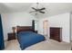 This bedroom features a ceiling fan, neutral carpet, and a spacious layout at 14170 W Warren Dr, Lakewood, CO 80228