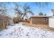 Large backyard with partial snow cover, providing ample outdoor space at 383 S Vaughn Way, Aurora, CO 80012