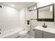 Updated bathroom features a white subway tile shower and gray vanity at 383 S Vaughn Way, Aurora, CO 80012