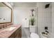 Bathroom with granite countertop and tiled shower at 383 S Vaughn Way, Aurora, CO 80012