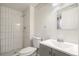 Modern bathroom with white tile shower and gray vanity at 383 S Vaughn Way, Aurora, CO 80012