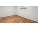 Simple bedroom with hardwood floors and a window at 383 S Vaughn Way, Aurora, CO 80012