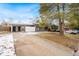 Front view of a ranch home with driveway, partially covered in snow at 383 S Vaughn Way, Aurora, CO 80012