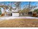 Ranch home with carport, partially covered in snow and mature trees at 383 S Vaughn Way, Aurora, CO 80012