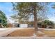 Ranch style home with carport and landscaping, partially covered in snow at 383 S Vaughn Way, Aurora, CO 80012