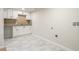 Basement laundry room with white cabinets and granite countertop at 383 S Vaughn Way, Aurora, CO 80012