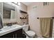 Well-lit bathroom featuring a modern vanity and decorative mosaic tile work around the mirror at 6495 E Happy Canyon Rd # 163, Denver, CO 80237