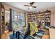 Cozy bedroom featuring built in bookshelves and a large window at 6495 E Happy Canyon Rd # 163, Denver, CO 80237