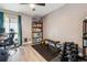 Bedroom featuring wood flooring, large window, and exercise equipment at 6495 E Happy Canyon Rd # 163, Denver, CO 80237