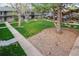 Well-maintained common area with lush green grass, mature trees, and walking path at 6495 E Happy Canyon Rd # 163, Denver, CO 80237
