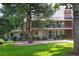Well-maintained townhouse with a manicured lawn and mature trees offering shade and curb appeal at 6495 E Happy Canyon Rd # 163, Denver, CO 80237