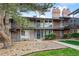 Charming townhome exterior with a well-manicured front yard at 6495 E Happy Canyon Rd # 163, Denver, CO 80237