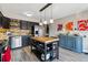 Bright kitchen with stainless steel appliances, butcher block island, and adjacent dining and bar area at 6495 E Happy Canyon Rd # 163, Denver, CO 80237