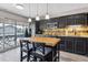 Open kitchen featuring stainless steel appliances, dark cabinetry, and a butcher block island at 6495 E Happy Canyon Rd # 163, Denver, CO 80237
