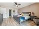 Primary bedroom showcasing ample space, neutral walls, wood flooring, and an ensuite bathroom access at 6495 E Happy Canyon Rd # 163, Denver, CO 80237