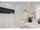 Modern bathroom with white tile and black accents at 2360 S Julian St, Denver, CO 80219