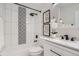 Clean bathroom with white vanity and black and white tile at 2360 S Julian St, Denver, CO 80219