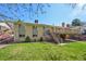 Beautiful backyard features lush green grass and a large deck with stairs, great for outdoor enjoyment at 2243 S Olive St, Denver, CO 80224