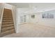 Finished basement area with carpeted floors, access to the outside, and a staircase to the upper level at 2243 S Olive St, Denver, CO 80224
