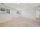 Finished basement features two windows, neutral carpet, and bright white walls at 2243 S Olive St, Denver, CO 80224