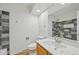 Tiled bathroom featuring a modern vanity and shower at 2243 S Olive St, Denver, CO 80224