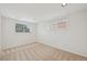 Bedroom featuring neutral carpet, bright white walls, and a bright window at 2243 S Olive St, Denver, CO 80224