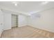 Bedroom features neutral carpet, a closet, and bright white walls at 2243 S Olive St, Denver, CO 80224