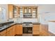 Well-lit kitchen with gas range and glass-front cabinets at 2243 S Olive St, Denver, CO 80224