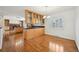 Eat-in kitchen with hardwood floors, wooden cabinets with glass, granite counters, and an open layout at 2243 S Olive St, Denver, CO 80224