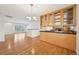 Updated kitchen with hardwood floors, wooden cabinetry, granite counters, open to a cozy living area at 2243 S Olive St, Denver, CO 80224
