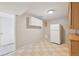 This area offers a kitchenette with vintage cabinetry, a refrigerator, and laminate floors at 2243 S Olive St, Denver, CO 80224