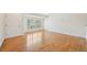 Bright living area featuring hardwood floors, large windows with shutters, and freshly painted white walls at 2243 S Olive St, Denver, CO 80224