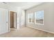 Cozy bedroom features neutral carpet, sunlit windows, and an open closet at 2958 Oxley St, Strasburg, CO 80136