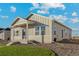 One-story home with light beige siding, a covered porch, and landscaping at 2958 Oxley St, Strasburg, CO 80136