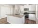 Stylish kitchen with stainless steel appliances, center island, and open layout at 2958 Oxley St, Strasburg, CO 80136