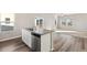 Modern kitchen island with stainless steel dishwasher and sink, connecting to the living room at 2958 Oxley St, Strasburg, CO 80136
