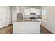 Modern kitchen featuring stainless steel appliances, a large island, and sleek countertops at 2958 Oxley St, Strasburg, CO 80136