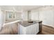 Modern kitchen with stainless steel appliances and an island perfect for entertaining at 2958 Oxley St, Strasburg, CO 80136