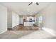 Open-concept living room and kitchen with modern appliances and beautiful wood and carpet flooring at 2958 Oxley St, Strasburg, CO 80136