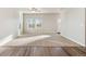 Bright living room featuring neutral carpet, ample natural light, and a ceiling fan at 2958 Oxley St, Strasburg, CO 80136