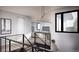 Modern stairway featuring sleek metal railings, abundant natural light, and a stylish design at 4852 Isabell Ct, Golden, CO 80403