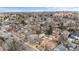 Expansive aerial view of a residential area featuring tree-lined streets, diverse home styles, and distant buildings at 2626 S Pennsylvania St, Denver, CO 80210