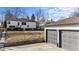 Exterior view of house with yard and detached two-car garage at 2626 S Pennsylvania St, Denver, CO 80210