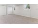 Finished basement area with neutral carpeting and bright windows at 2626 S Pennsylvania St, Denver, CO 80210