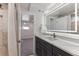 Modern bathroom featuring sleek vanity with quartz countertop, illuminated mirror, and stylish fixtures at 2626 S Pennsylvania St, Denver, CO 80210