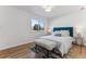 Cozy bedroom with a plush bed, side tables and a bright window at 2626 S Pennsylvania St, Denver, CO 80210